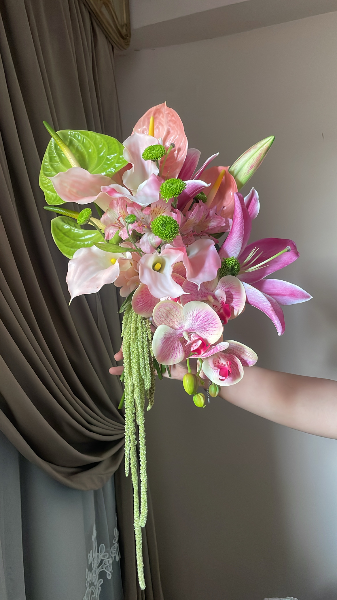 Natural lilies, anthuriums, amaranthsues and greenery.